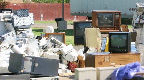 Professionals managing electronic waste during office clearance