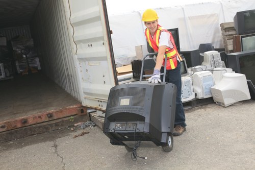 Professionals removing office furniture for clearance